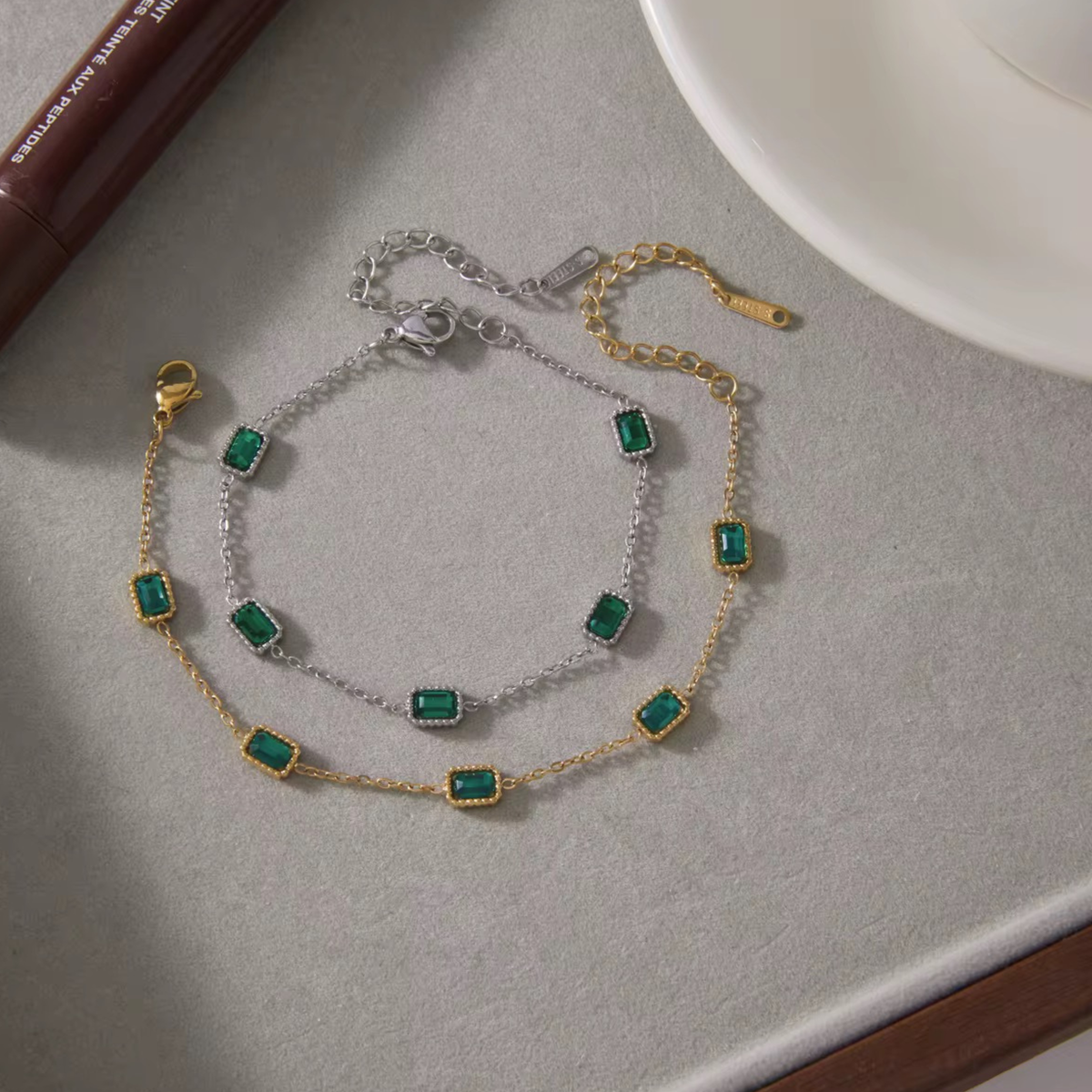 Emerald Muse Bracelet crafted from stainless steel with 18K gold plating and emerald-inspired crystals, designed for elegant everyday wear.